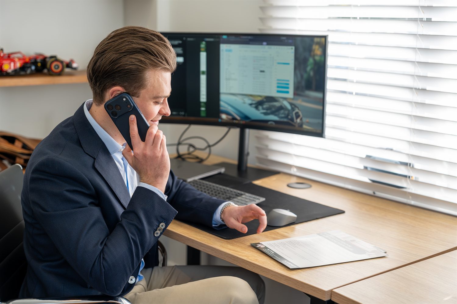 Alex Toohey reviewing a client's lending over the phone