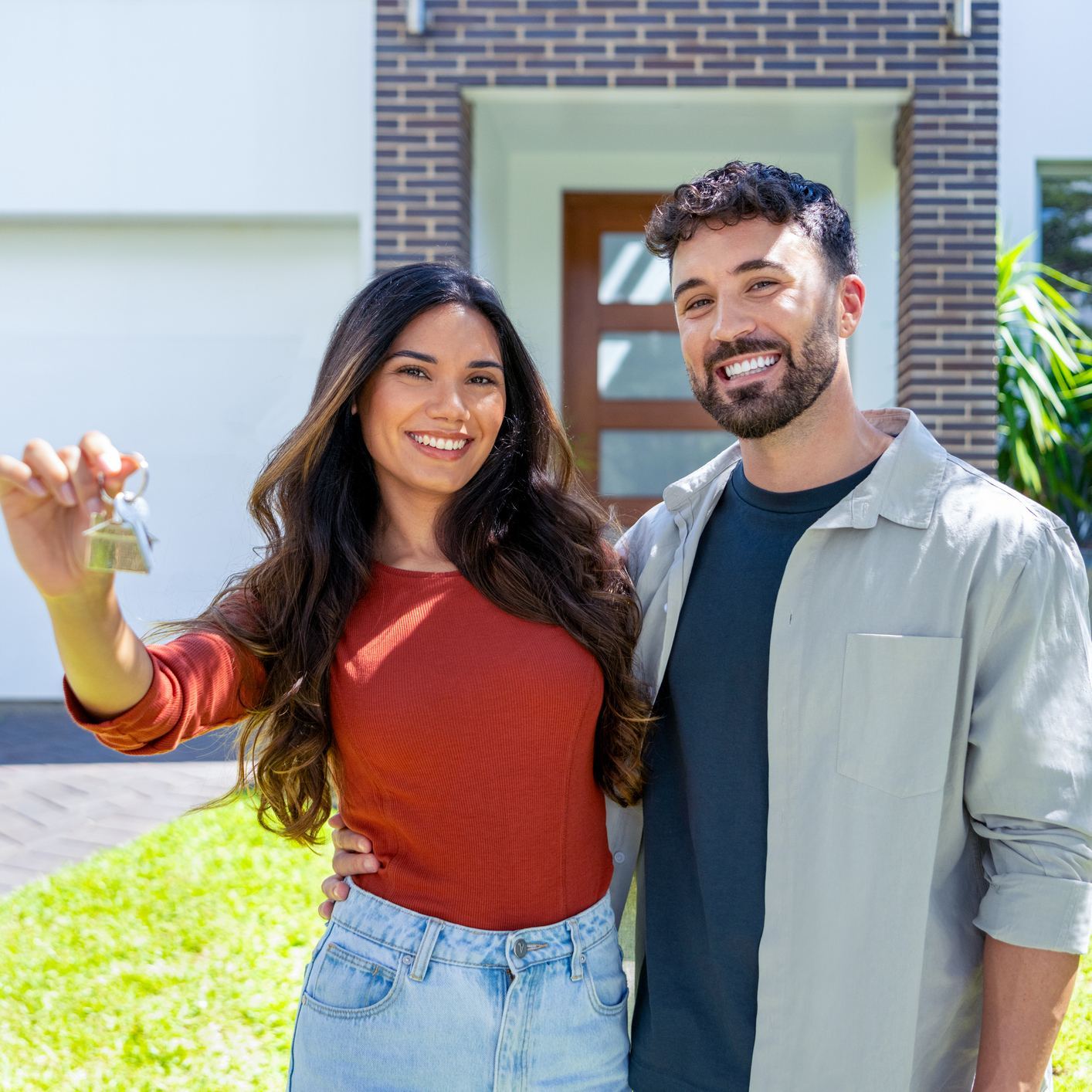 A couple holding the keys to the home they have just bought