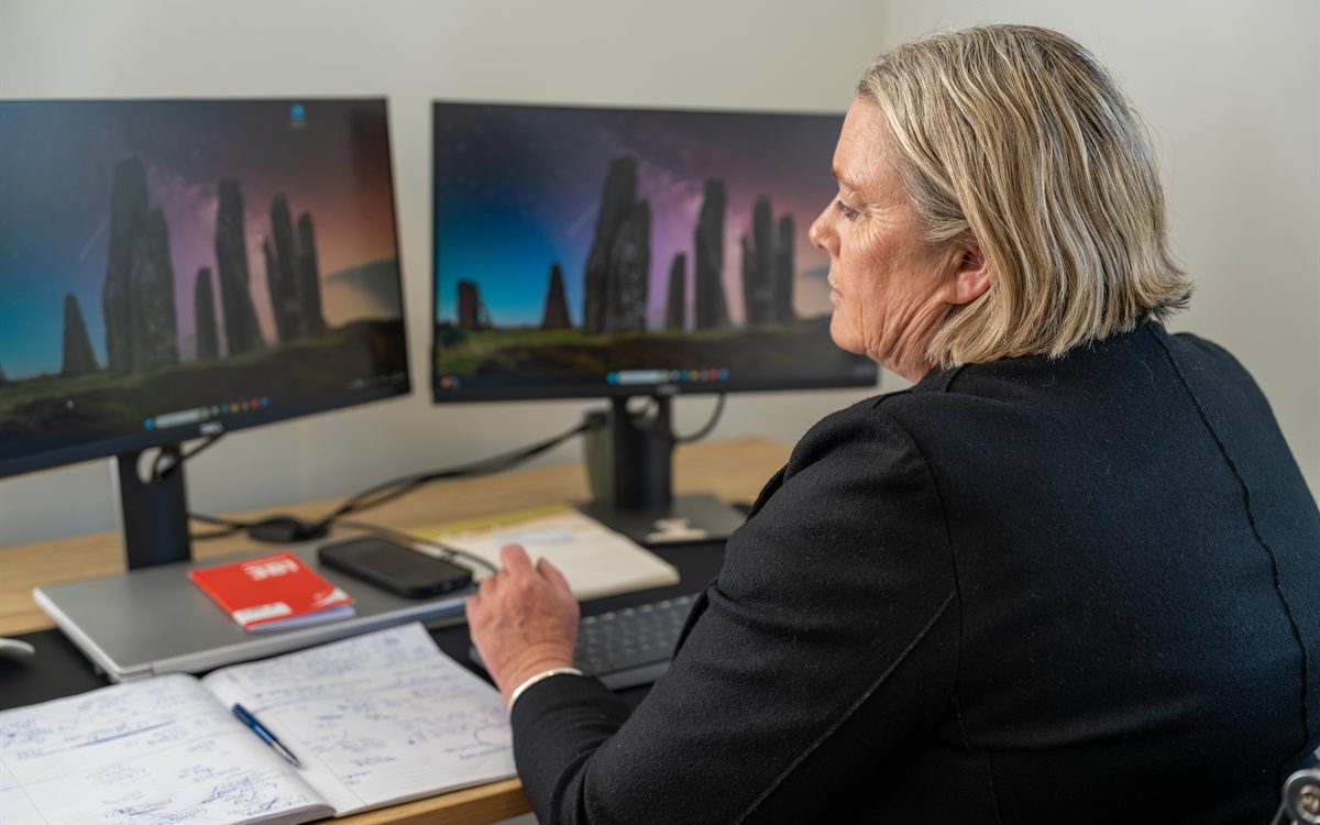Megan working through a client purchase at her desk