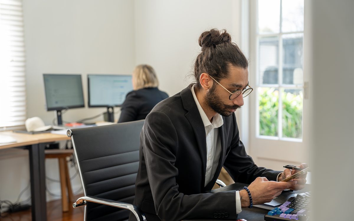 Sam reviewing investment lending numbers in the Journey Mortgages office